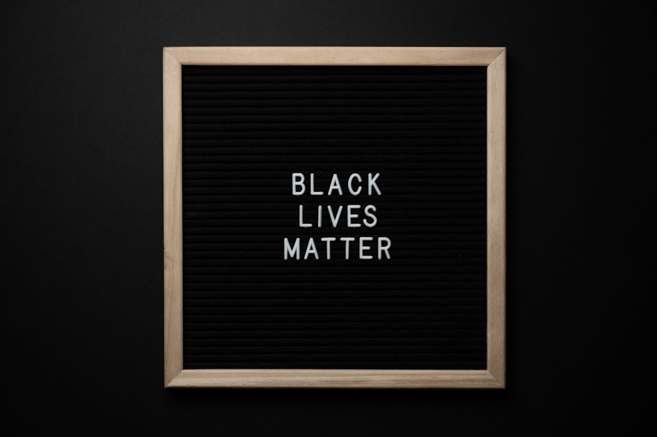 A sign with the text 'Black Lives Matter' against a black background for justice awareness.